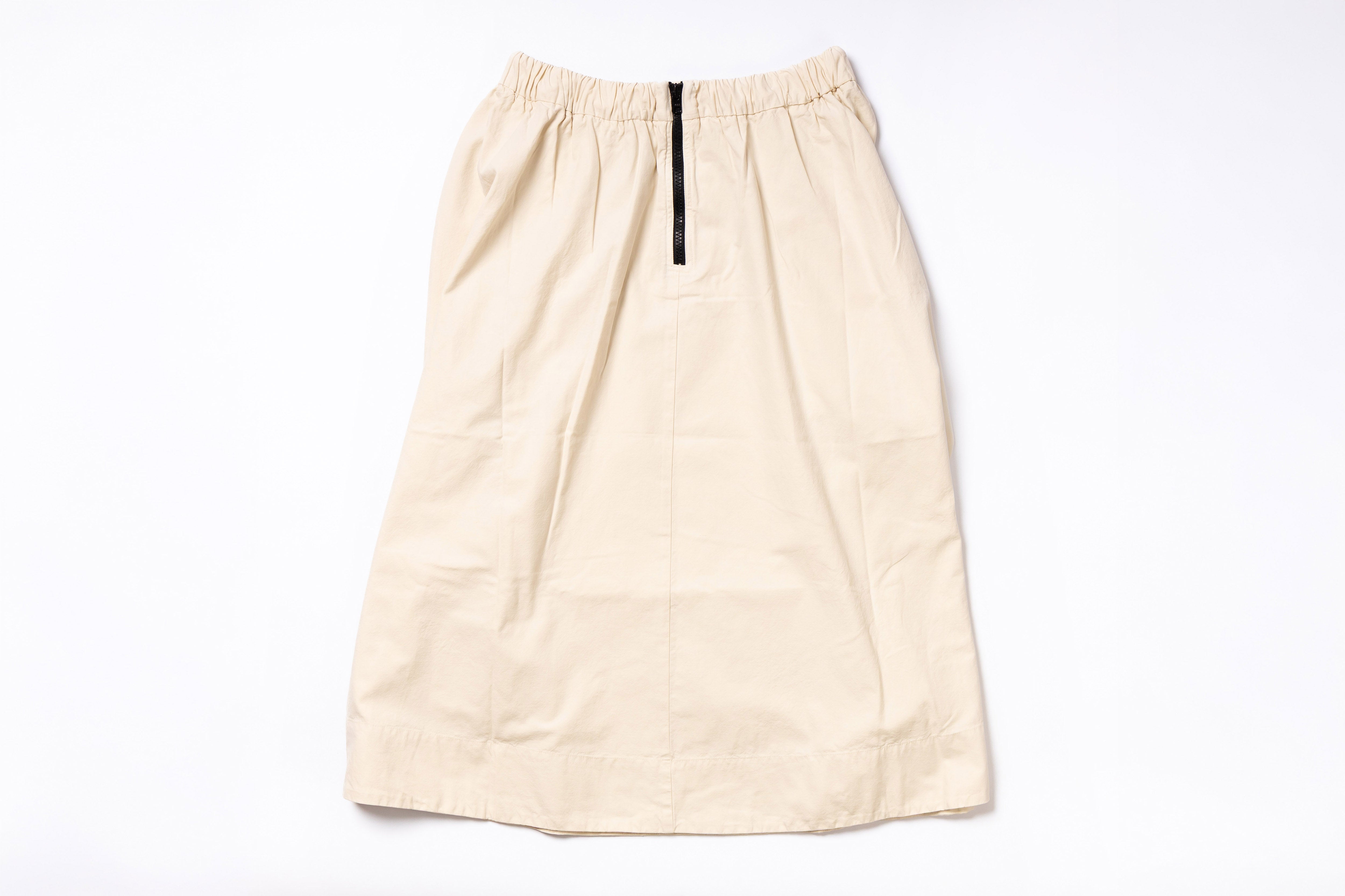 Beige skirt with a black zipper on a white background