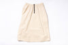 Beige skirt with a black zipper on a white background