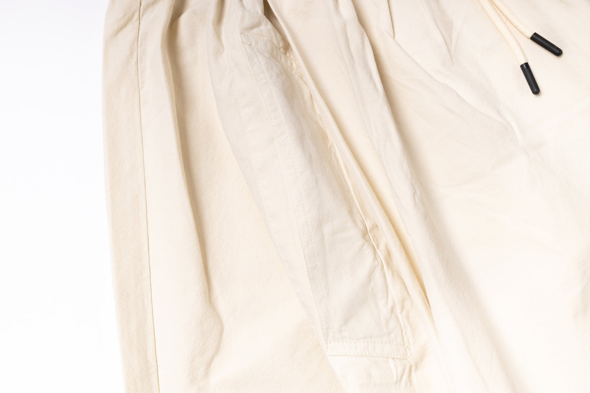 Close-up of a beige fabric with a zipper on a white background