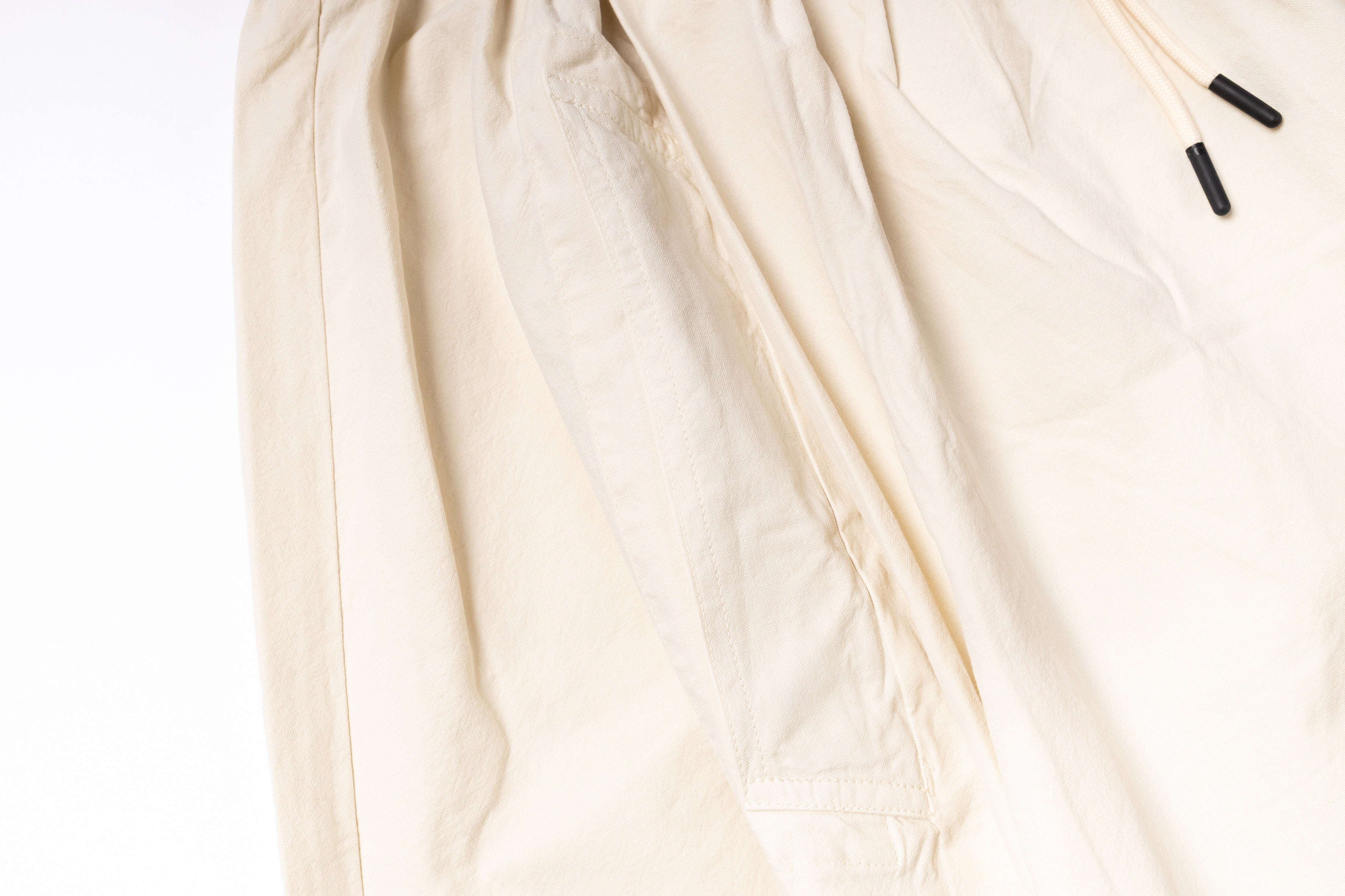 Close-up of a beige fabric with a zipper on a white background