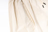 Close-up of a beige fabric with a zipper on a white background