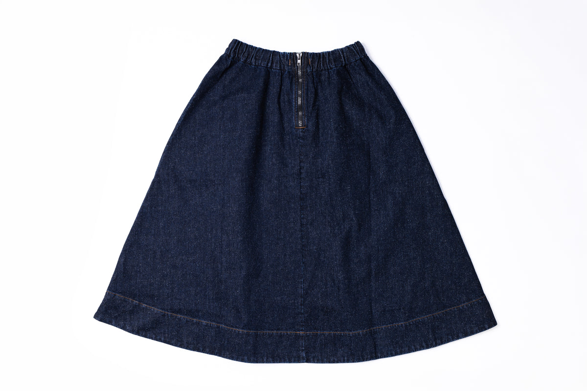 A dark indigo denim A-line skirt with an elastic waistband and a central zipper, laid flat on a white background.