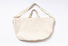 Beige tote bag with shoulder strap on a white background