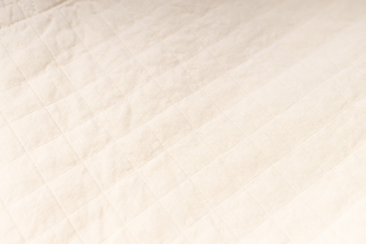 Close-up of a textured beige fabric surface