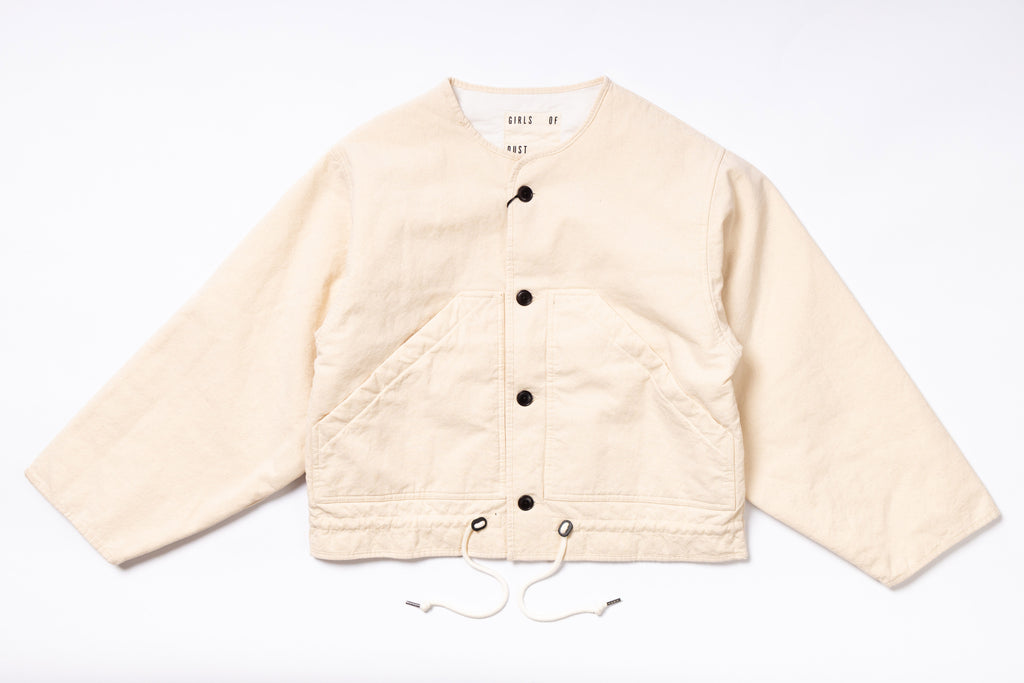 Beige quilted jacket with button details on a white background