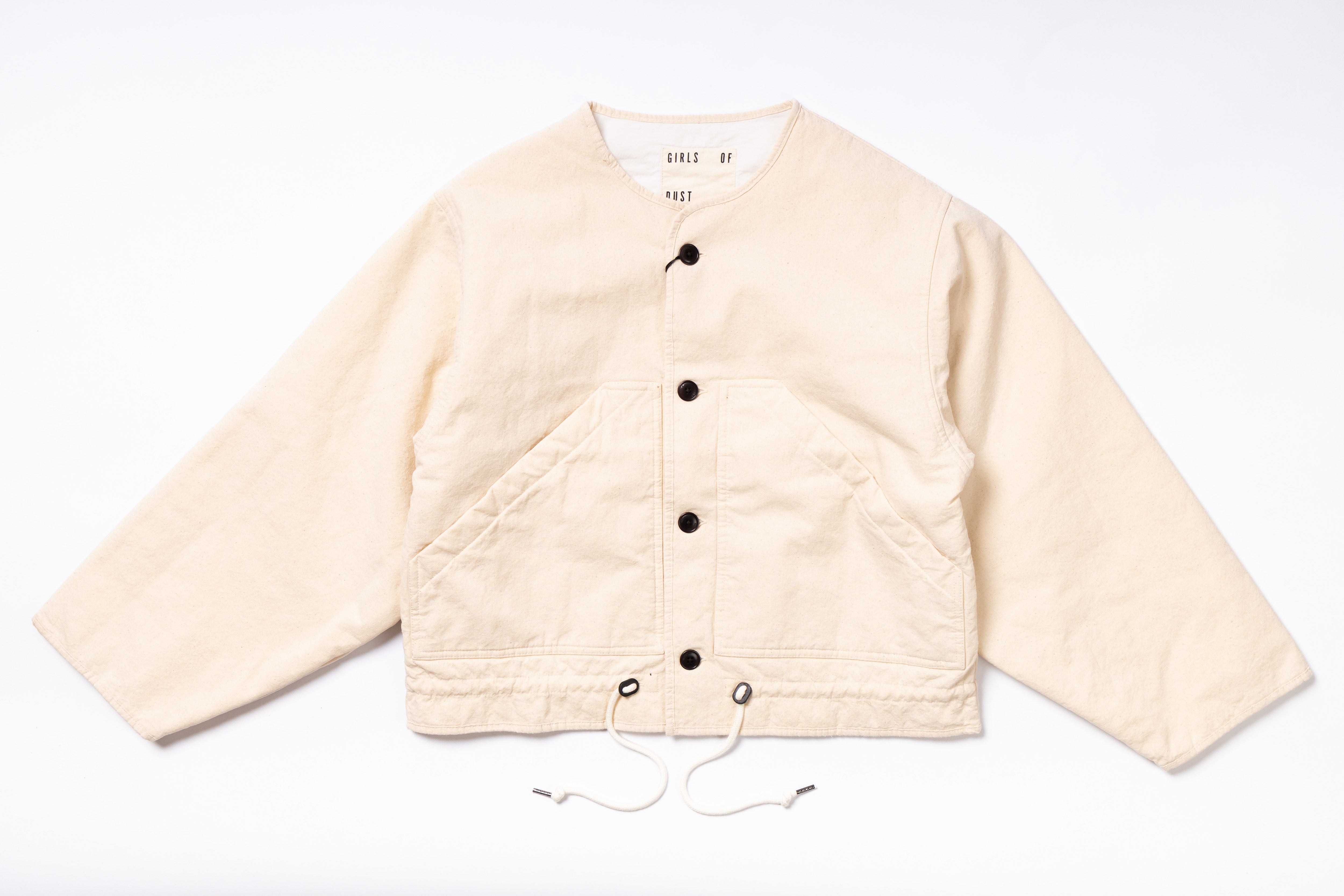 Beige quilted jacket with button details on a white background