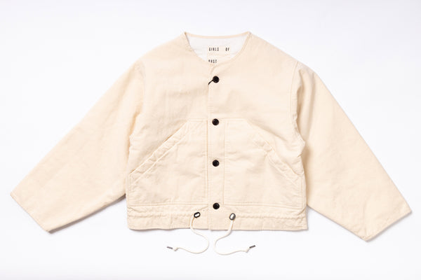 Beige quilted jacket with button details on a white background