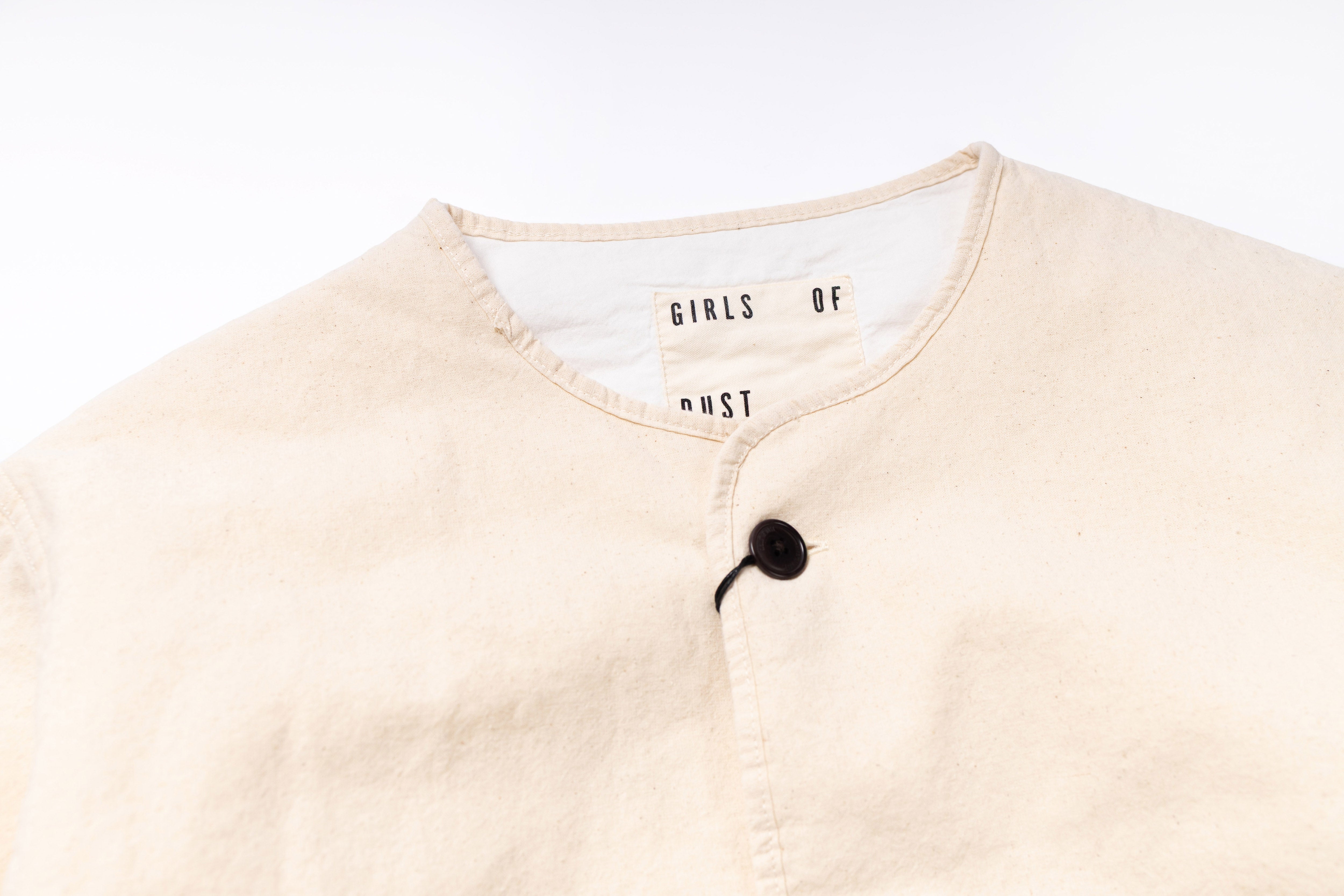 Beige cardigan with a brand label on a white background