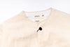 Beige cardigan with a brand label on a white background