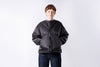 Person wearing a black puffer jacket on a white background