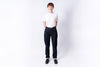 Person wearing a white t-shirt and dark jeans on a white background