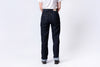 Person wearing dark blue jeans and a white shirt on a white background