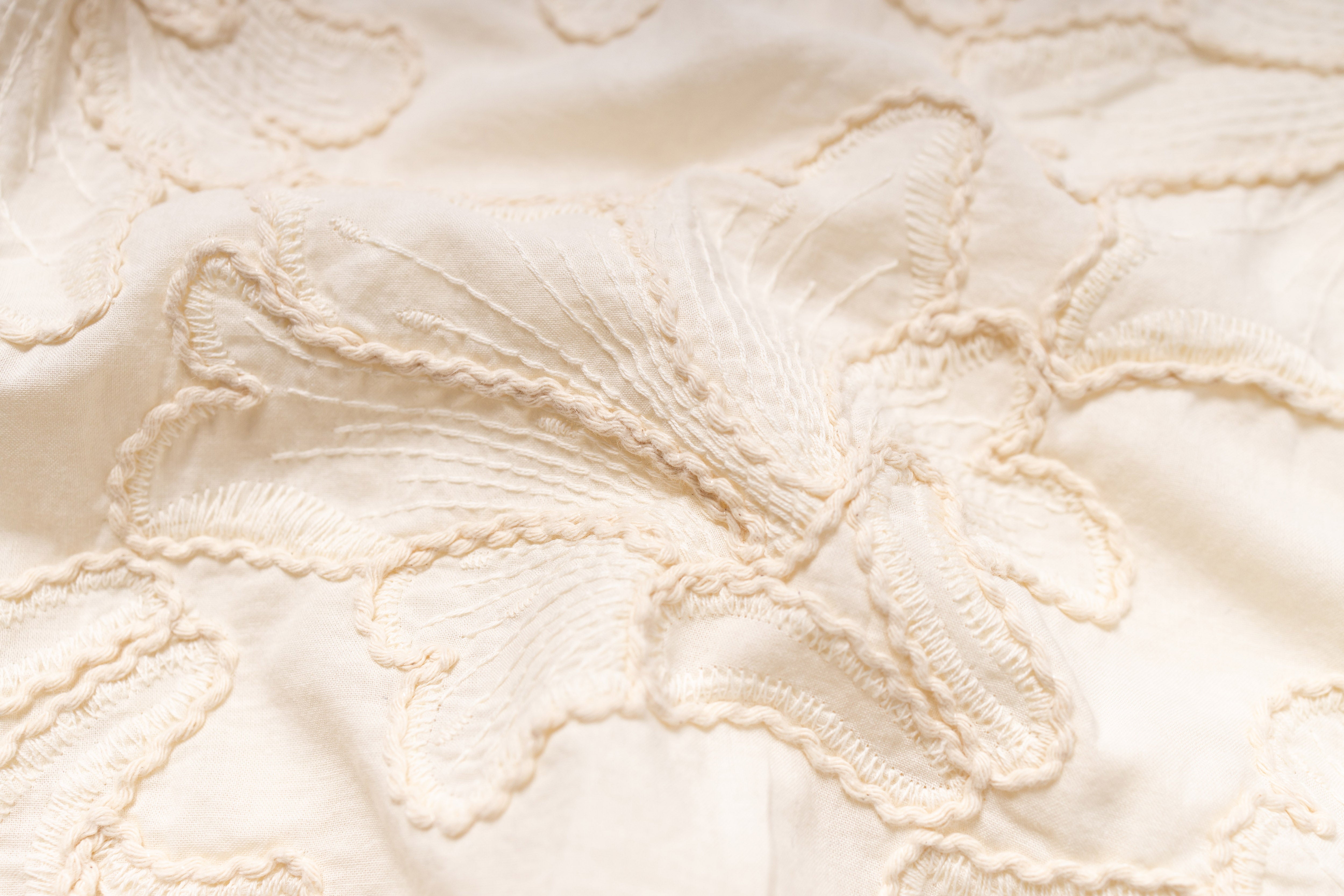 Close-up of textured beige fabric with floral pattern