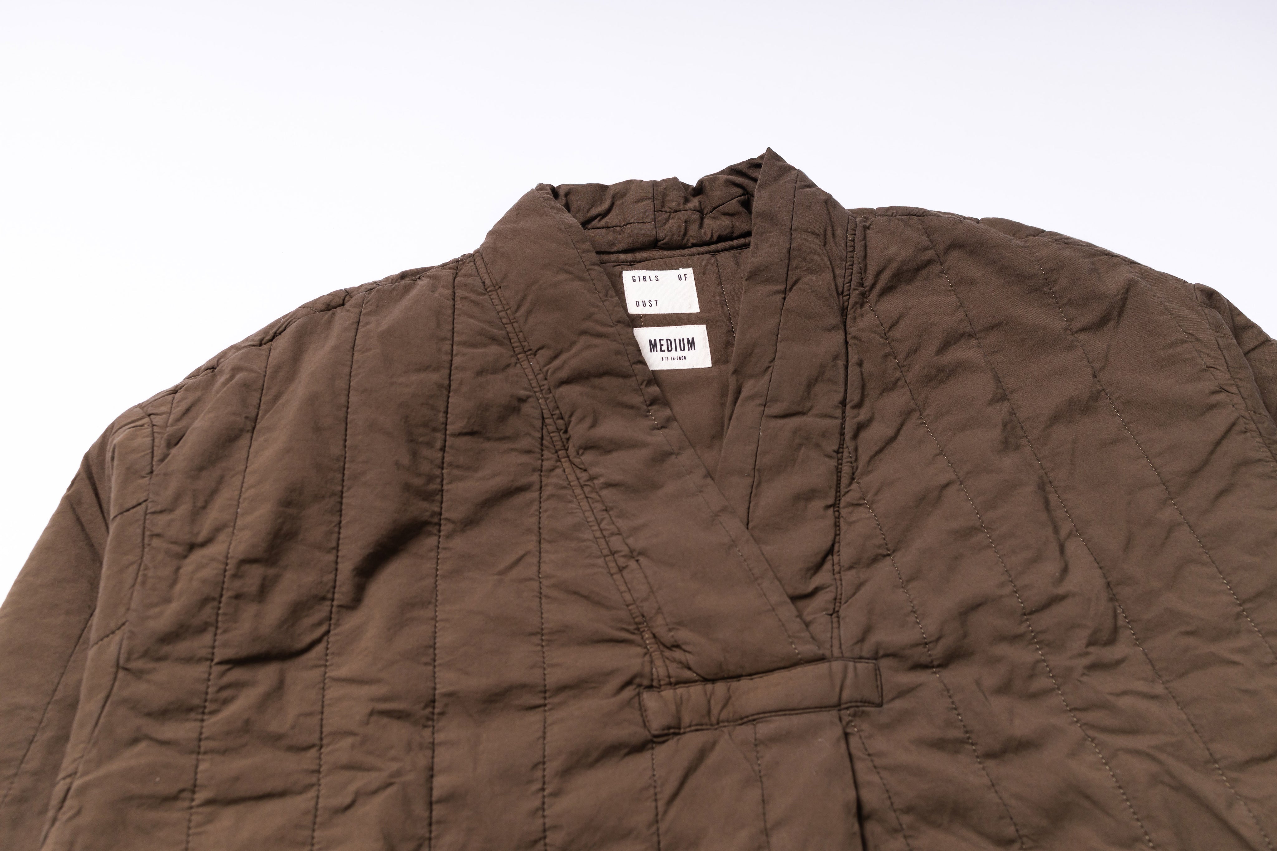 Brown jacket with a visible brand label on a white background