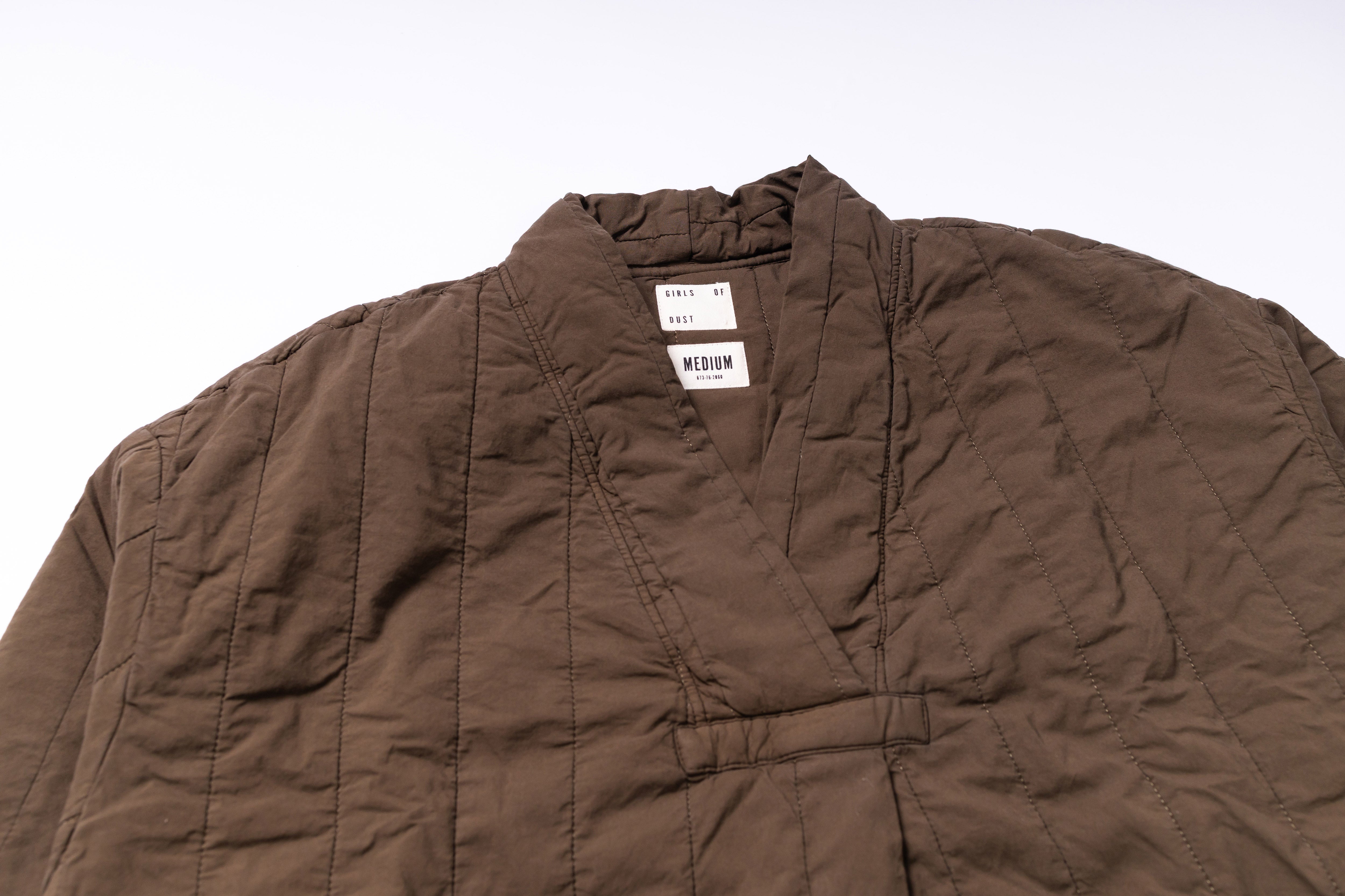 Brown jacket with a visible brand label on a white background
