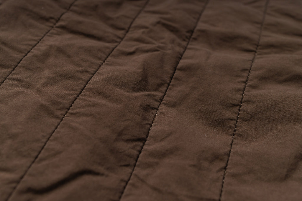 Brown fabric with visible stitching lines