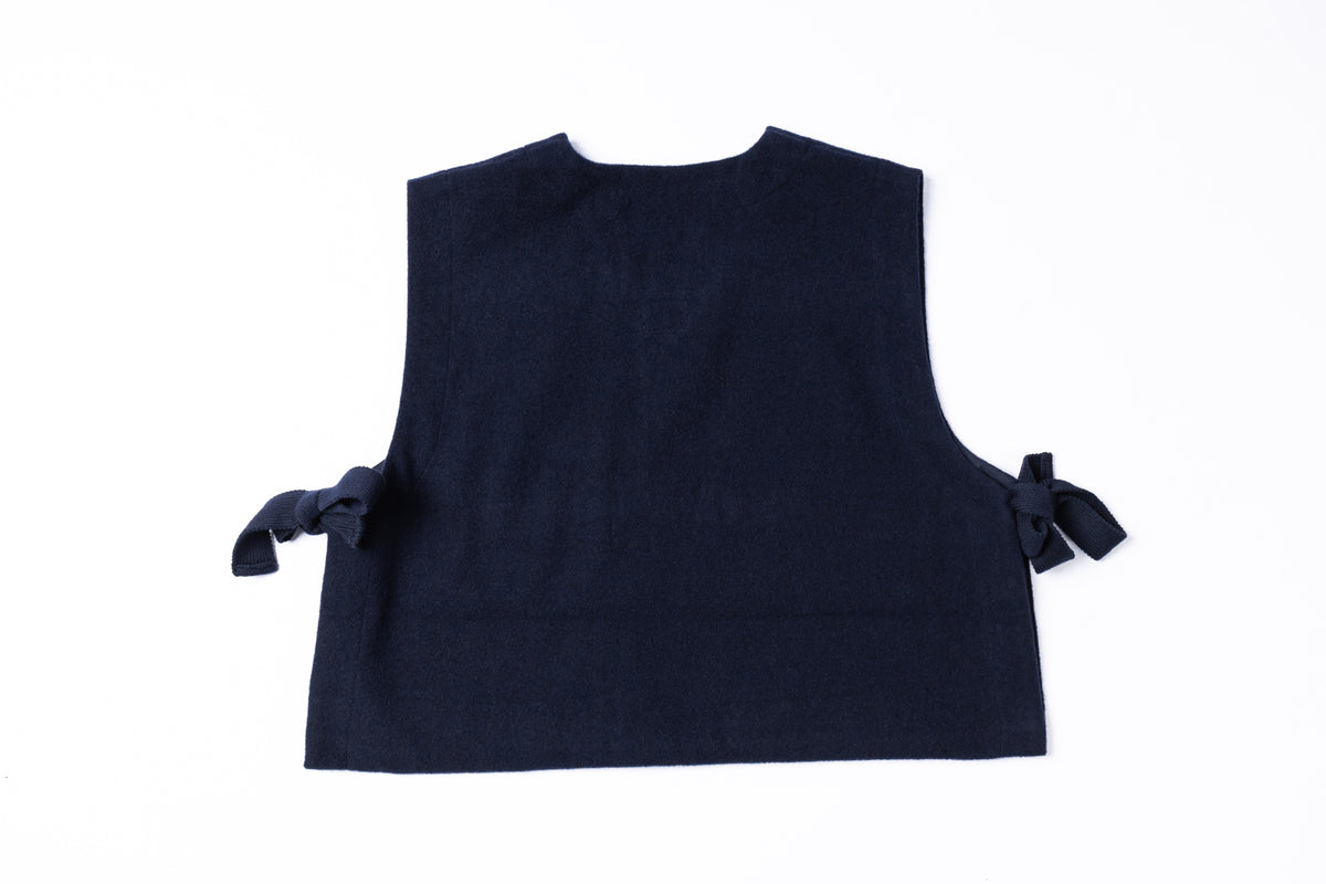 A dark navy blue sleeveless top or vest with side tie details, shown from the back against a plain white background.