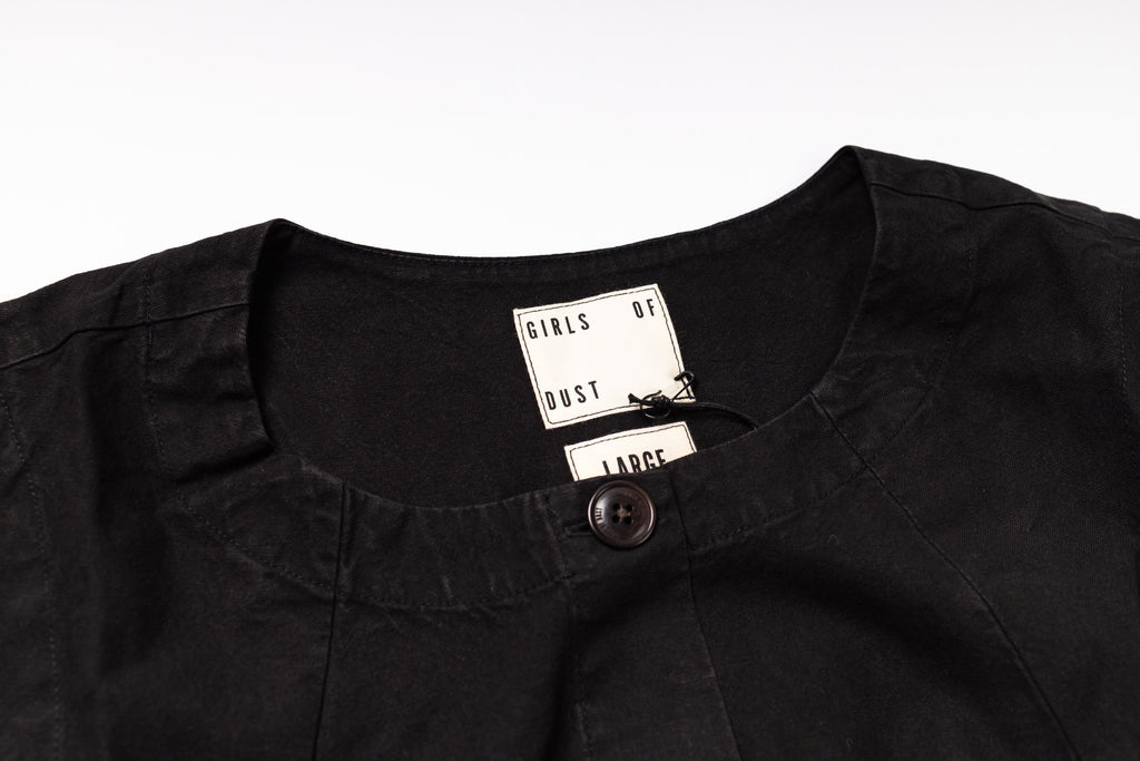 Black shirt with a tag on a white background