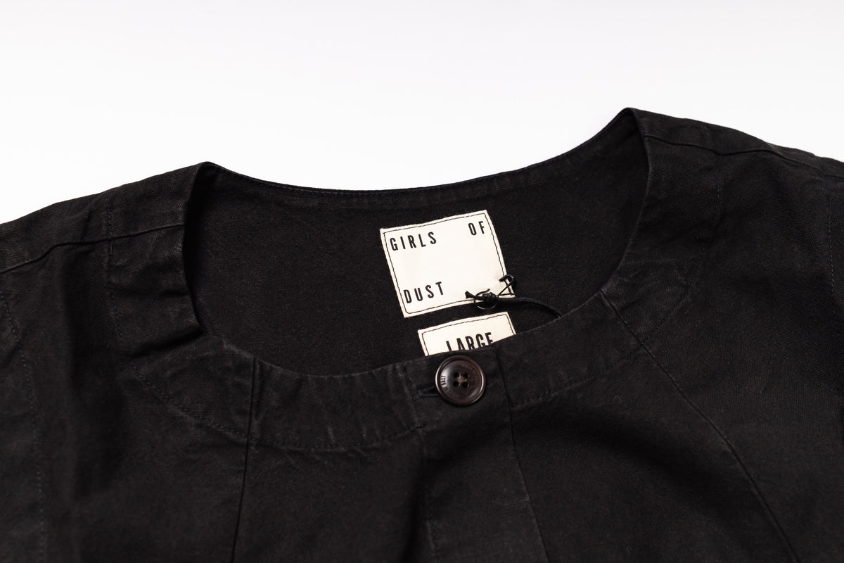 Black shirt with a tag on a white background