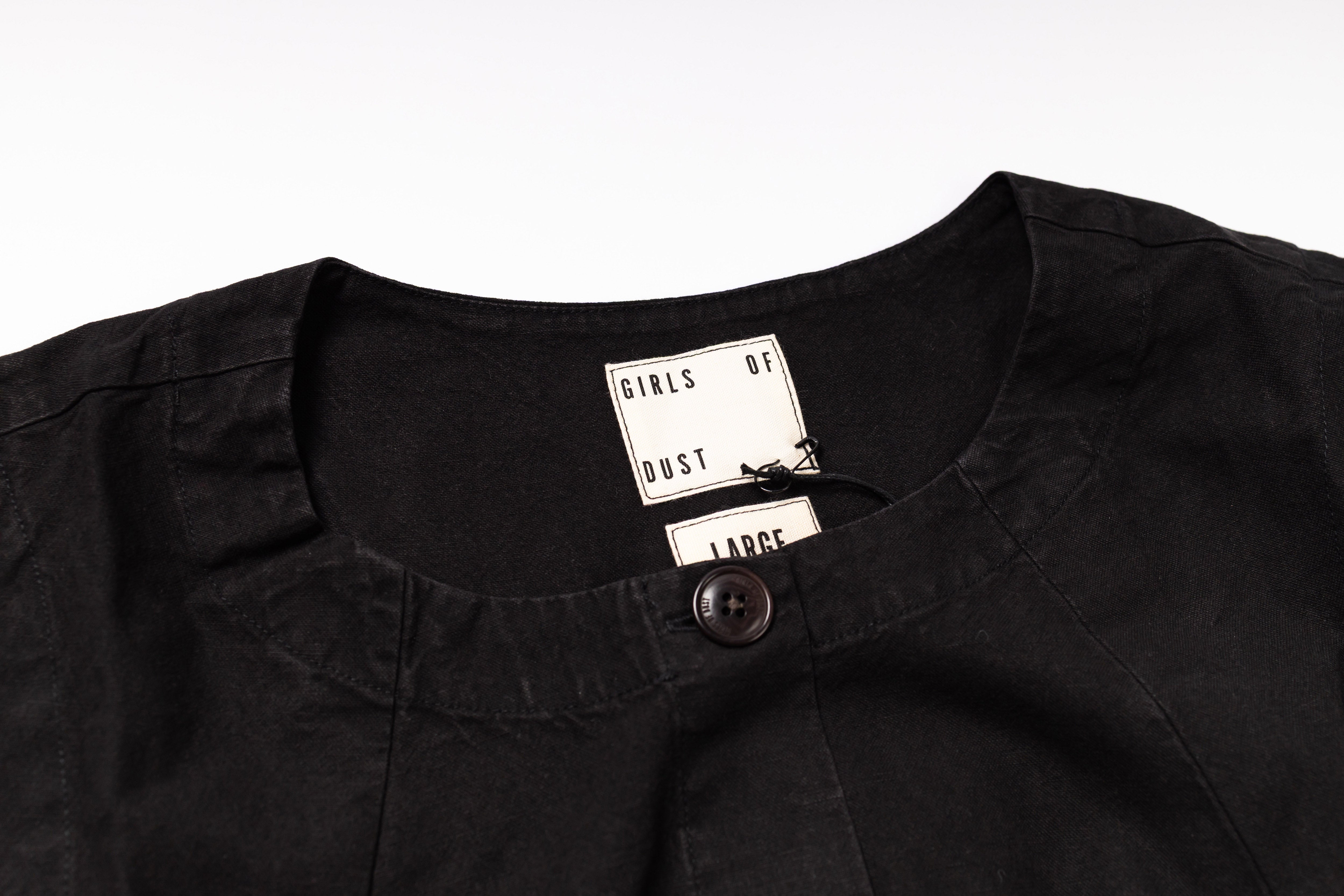 Black shirt with a tag on a white background