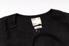 Black shirt with a tag on a white background