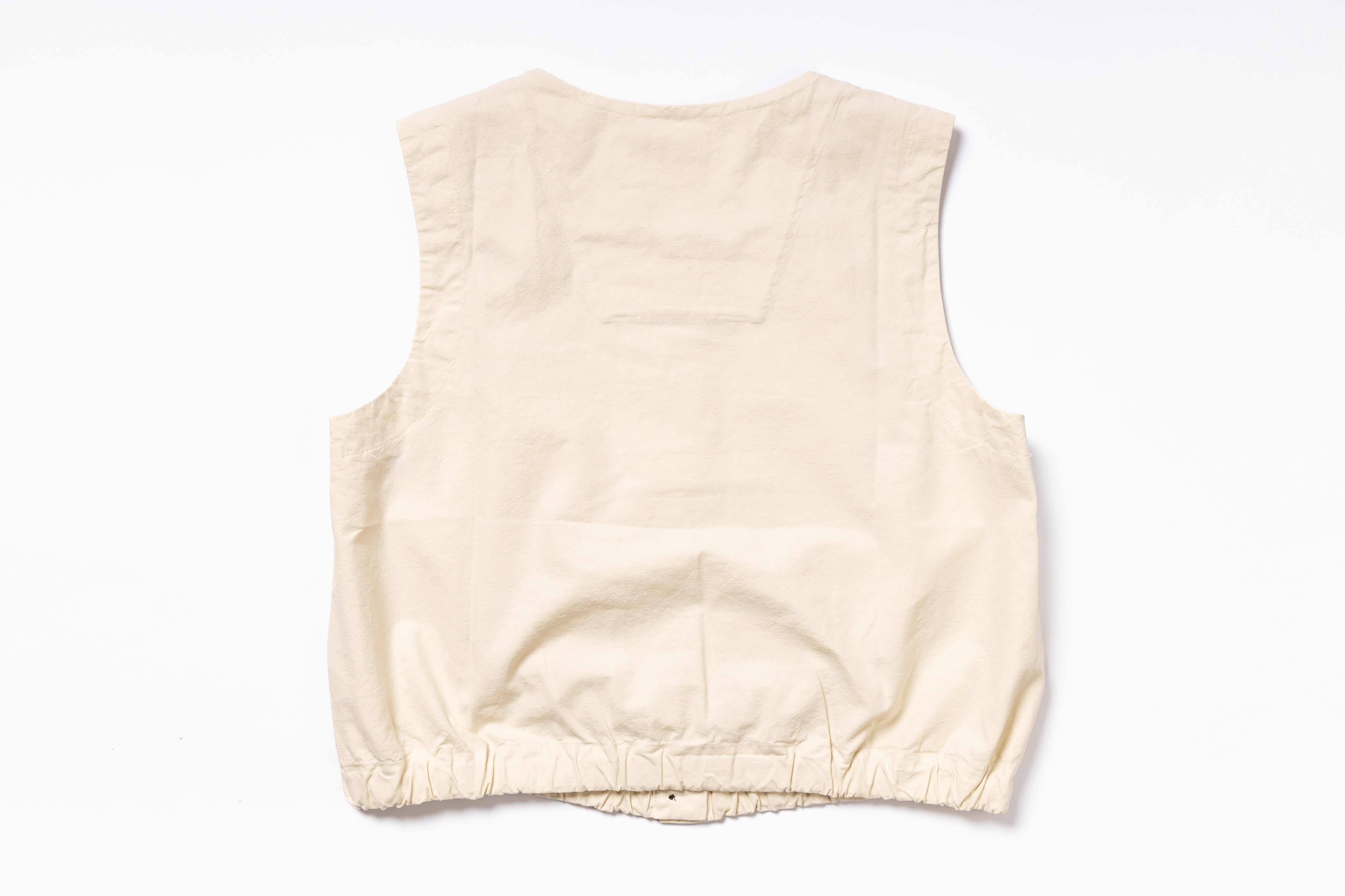 Beige sleeveless top on a white background