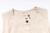 Beige sleeveless top with a tag on a white background