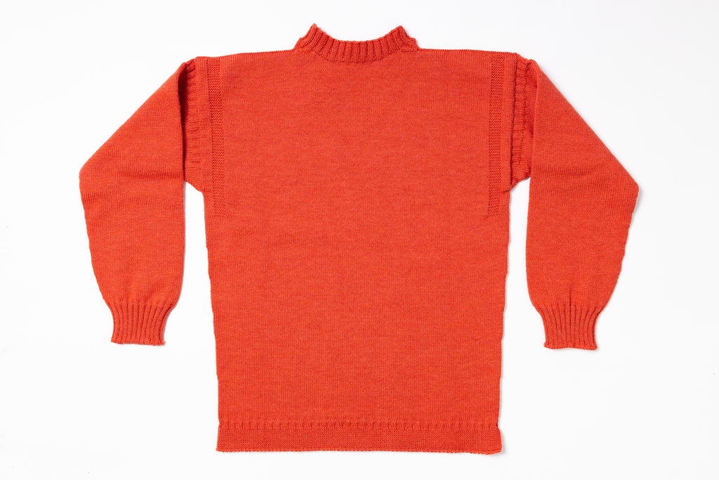 Back view of an orange sweater on a white background