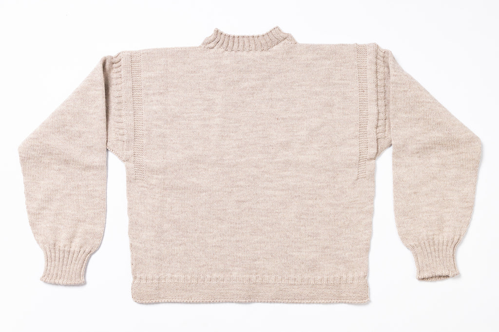 Beige knitted sweater on a white background