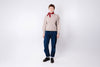 Person wearing a beige sweater, blue jeans, and a red scarf on a white background