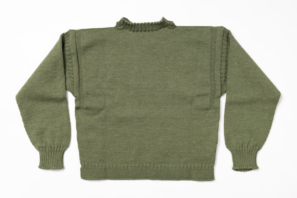Green knitted sweater on a white background