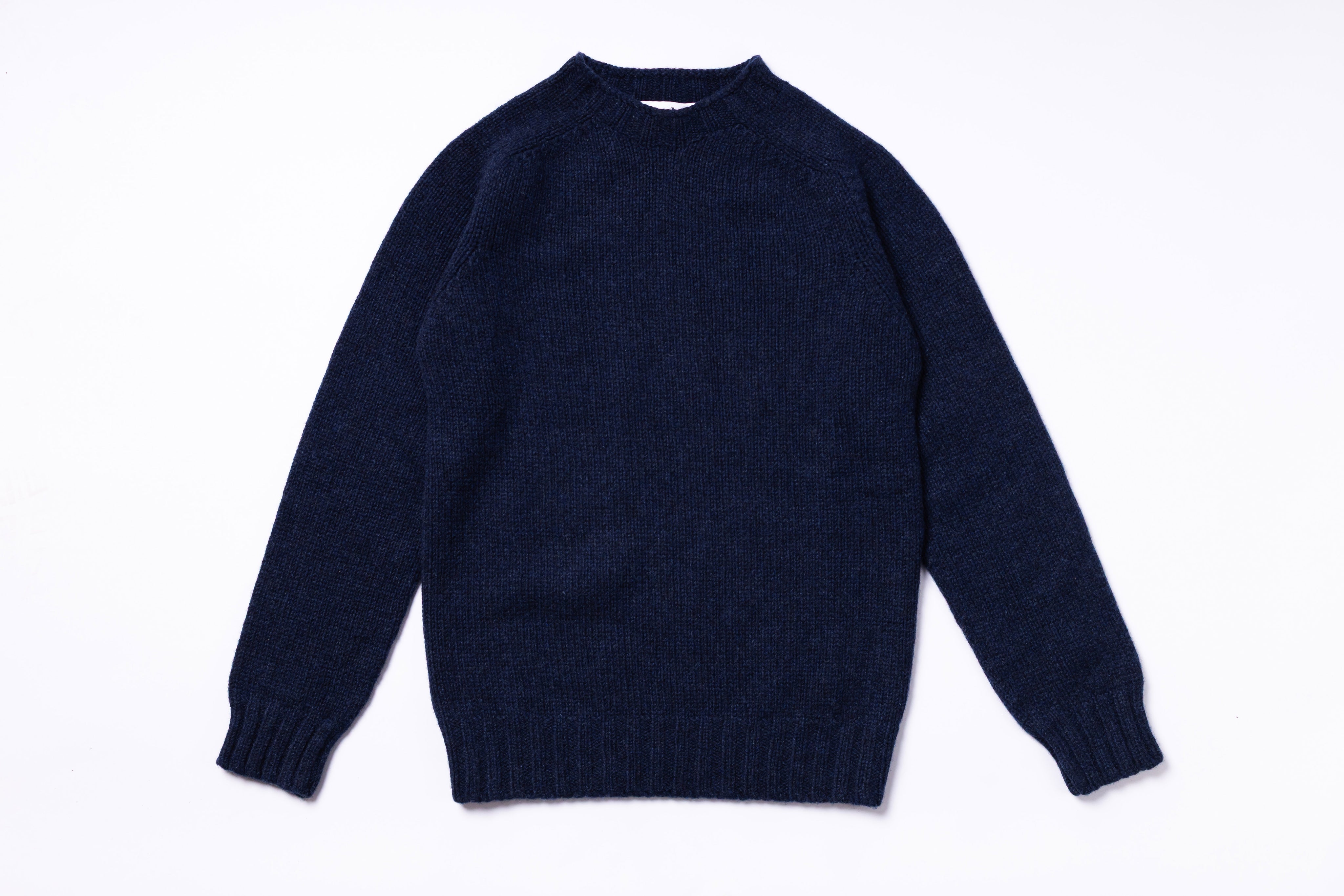 Navy blue sweater on a white background