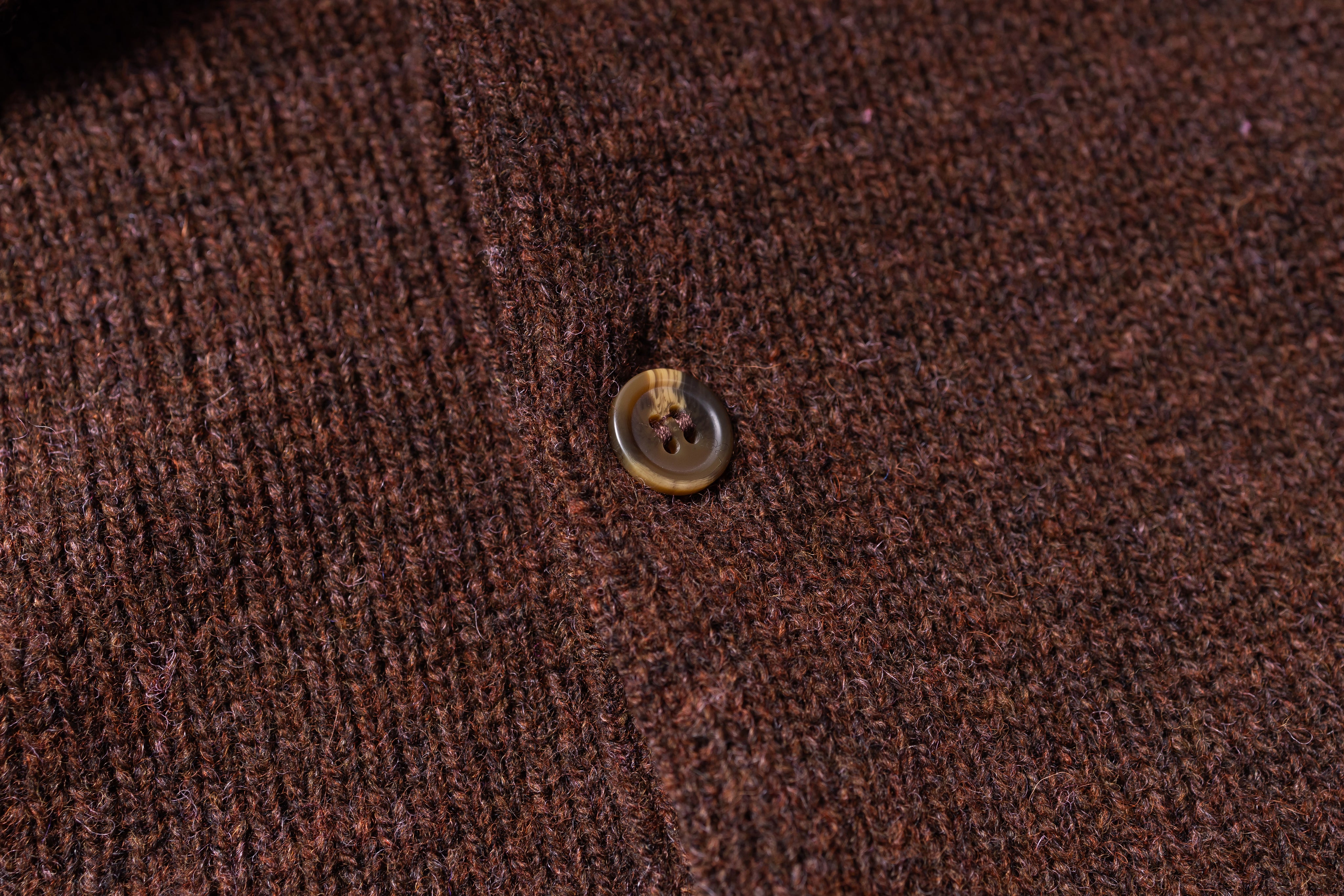 Close-up of a button on brown fabric
