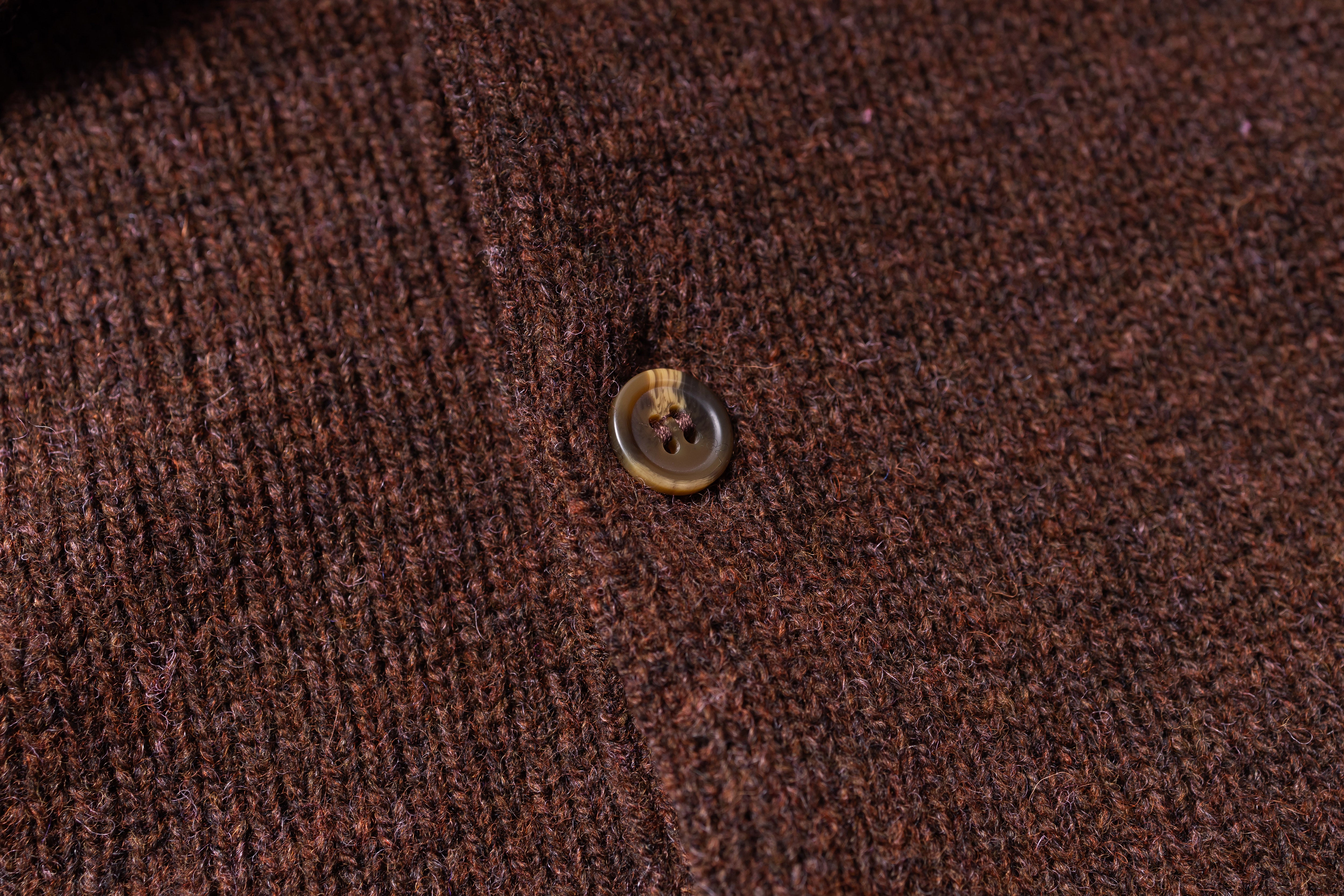 Close-up of a button on brown fabric