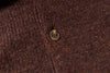 Close-up of a button on brown fabric