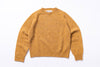 Mustard sweater with 'Harley' label on a white background