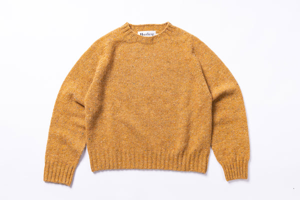 Mustard sweater with 'Harley' label on a white background