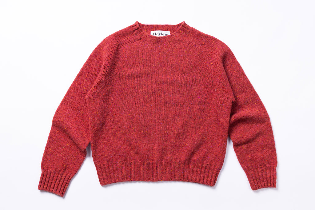 Pink jumper with 'Harley' label on a white background