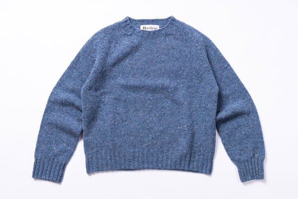 Light blue sweater with 'Harley' label on a white background