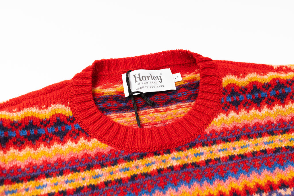 Colorful sweater with a Harley label on a white background
