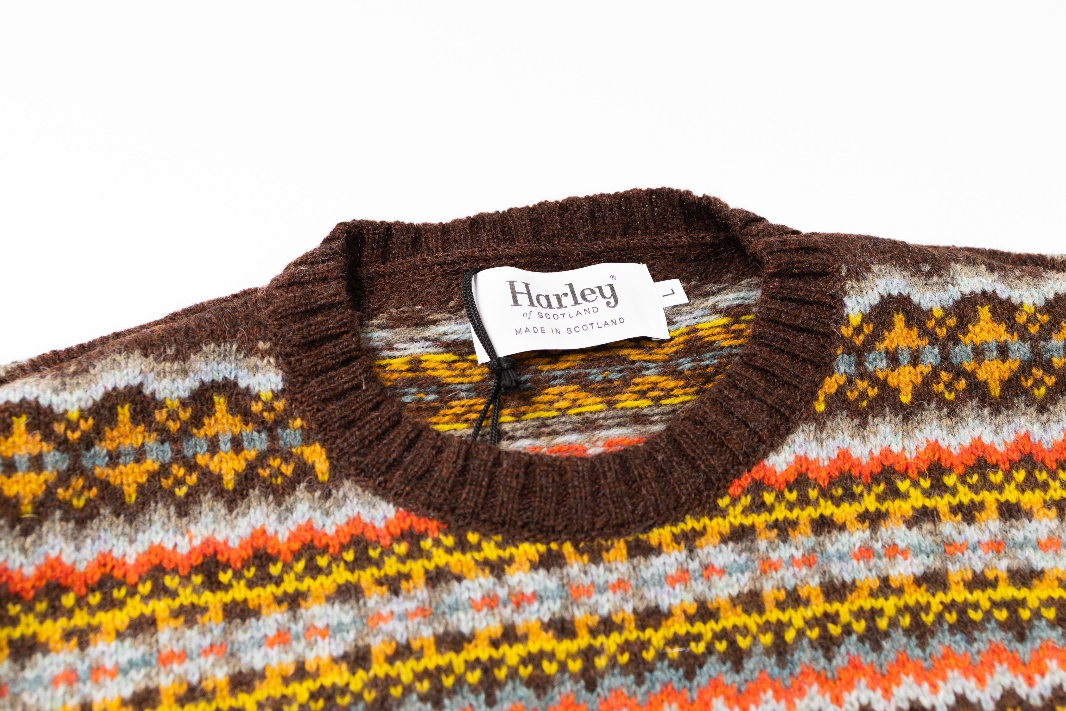 Knitted sweater with a colorful pattern and Harley brand label on a white background