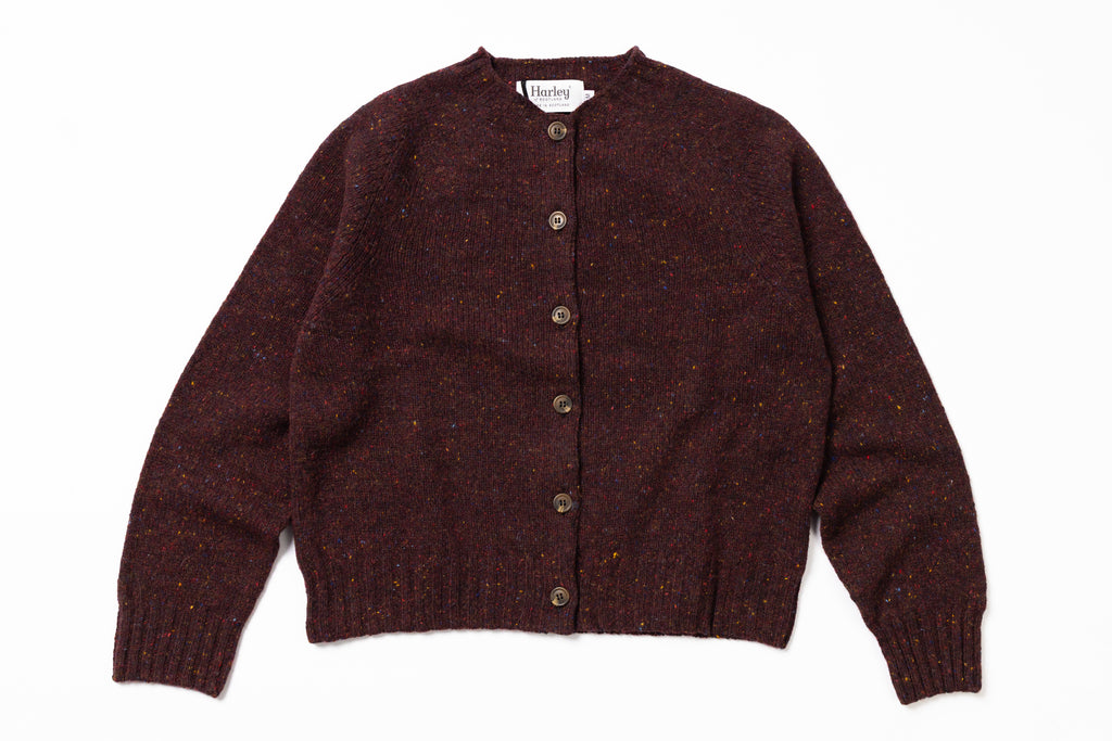 Brown knitted cardigan with buttons on a white background