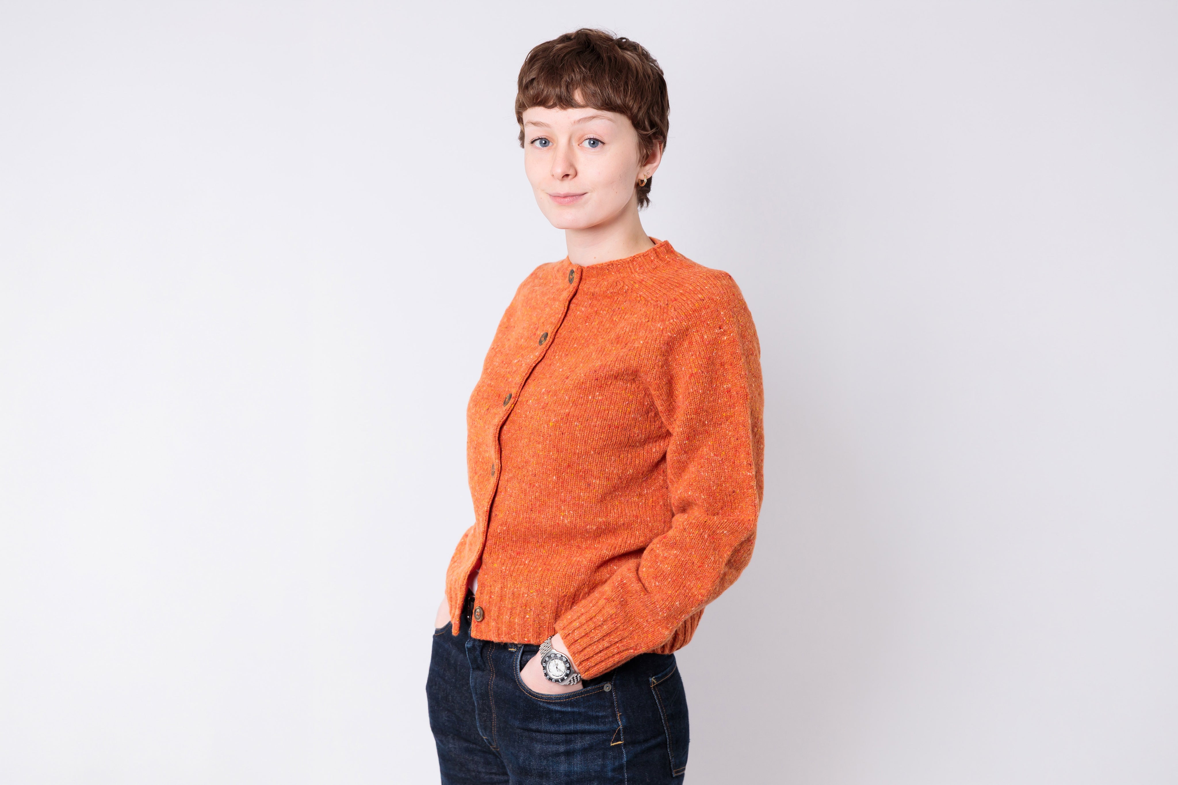 Woman wearing a knitted cardigan on a white background