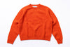 Orange sweater with 'Harley' label on a white background