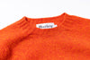 Light blue sweater with 'Harley' label on a white background zoomed in