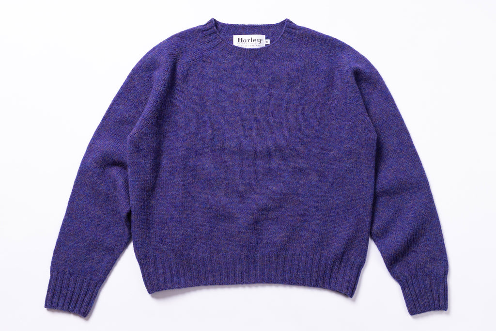 Purple sweater with 'Harley' label on a white background