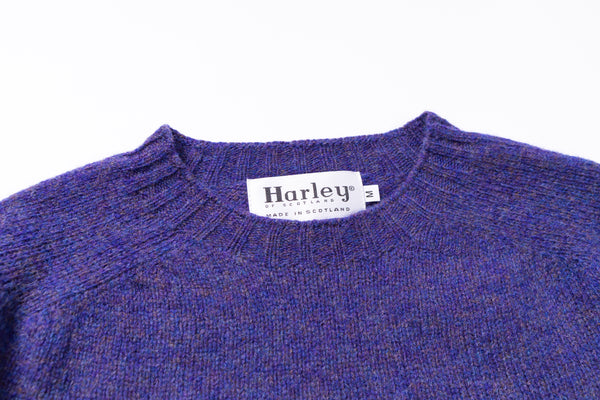 Light blue sweater collar with 'Harley' label on a white background