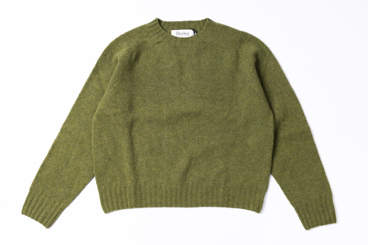 An olive green knit crewneck sweater laid flat against a solid white background.