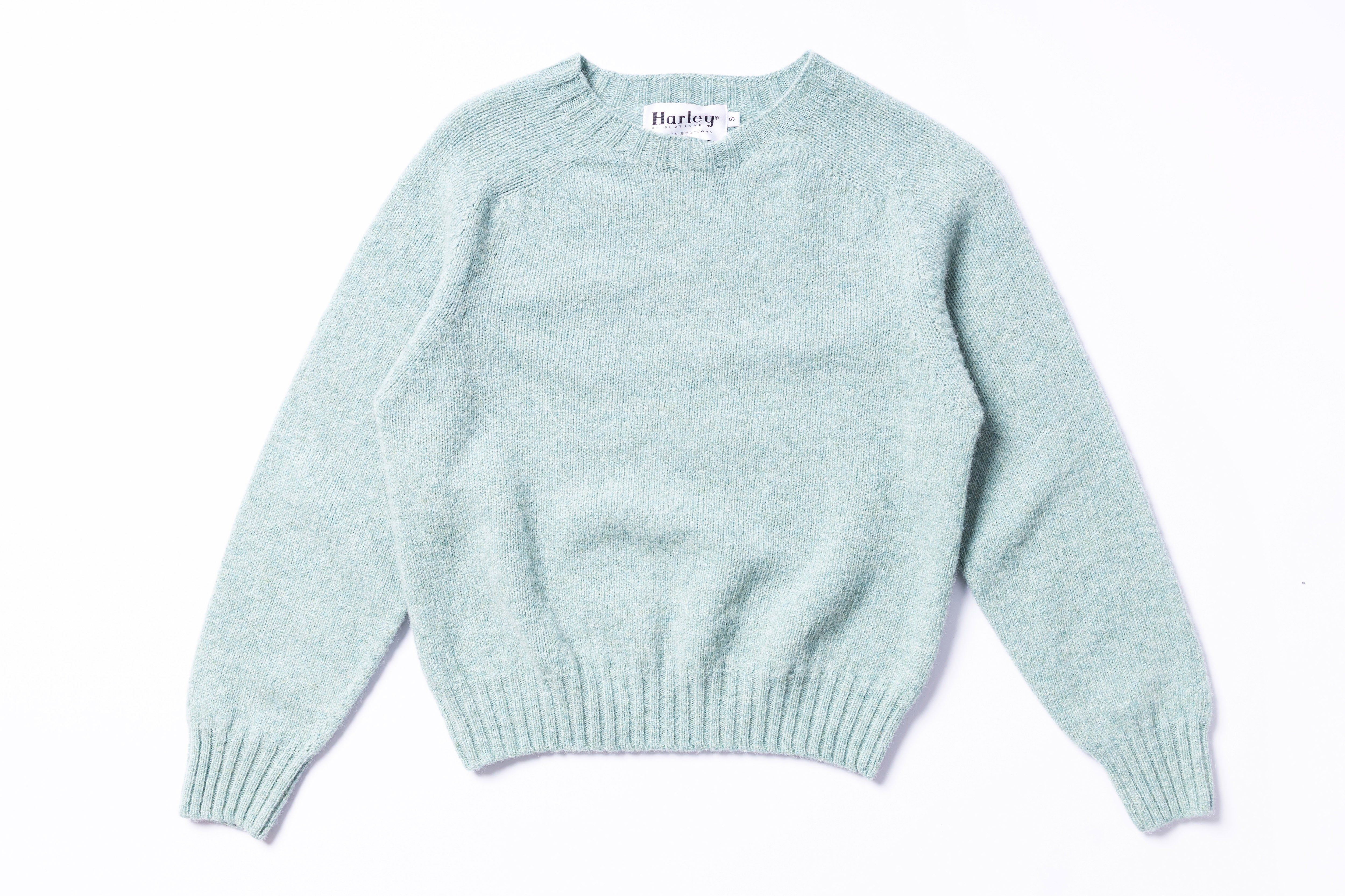 Light blue sweater with 'Harley' label on a white background