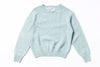 Light blue sweater with 'Harley' label on a white background